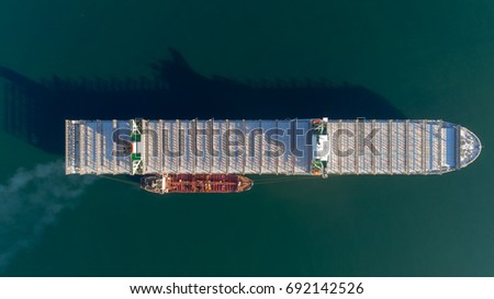Top view of a large empty container ship and a tanker standing side by side.