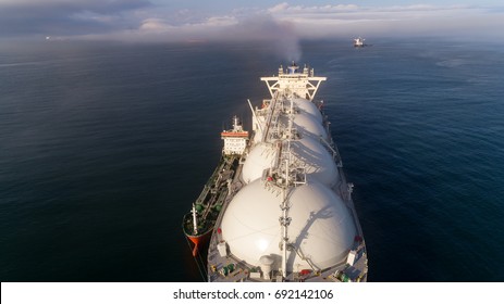 Top view of a large LNG tanker and a tanker standing side by side.