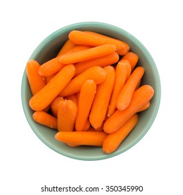 Top View Of A Large Serving Of Organic Small Baby Carrots In A Green Bowl Isolated On A White Background.