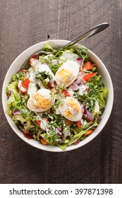 Top View Of Large White Bowl Of Deviled Egg Salad On Dark Wooden Background 