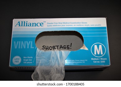 Top View Of Last Piece Of Medical Examination Glove From A Box. Close Up Photo Isolated On Black Background. Shortage Of Supply Of  Personal Protective Equipment (PPE) Supplies. April 07,2020