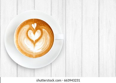 Top view latte art coffee on wood background.