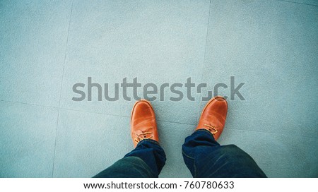Top view of leather shoes standing on stone floor tiles backgrounds