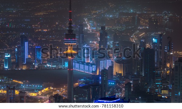 Top view of The Liberation Tower timelapse in Kuwait\
City illuminated at night with traffic on the road and city\
skyline. Kuwait, Middle\
East