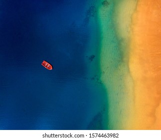 Top View Of A Lonely Red Boat Anchored Off The Coast Of Las Teresitas Beach. Tenerife, Canaries, Spain