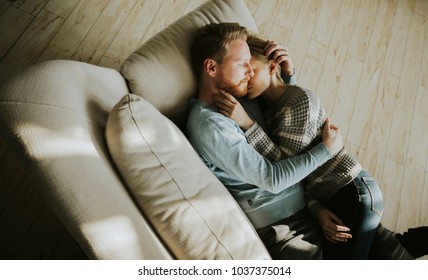 Top View At Loving Couple Lying Down On The Sofa In The Room