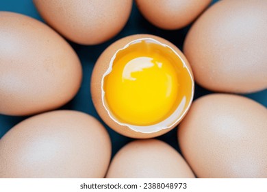 Top view macro shot of eggs with one chicken egg broken with yolk - Powered by Shutterstock