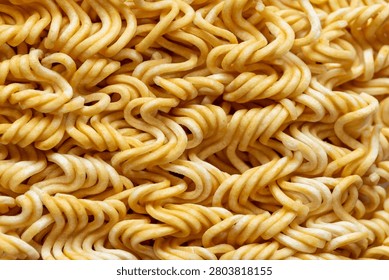 Top View Macro Texture of Uncooked Instant Noodle Block,A detailed close-up shot focusing on the intricate wavy texture of an uncooked instant noodle block, highlighting the pattern of dried wheat dough strands.