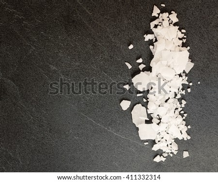 Top view of magnesium chloride flakes on a dark granite slate. Stock photo © 