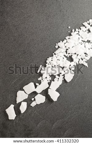 Top view of magnesium chloride flakes on a dark granite slate. Stock photo © 