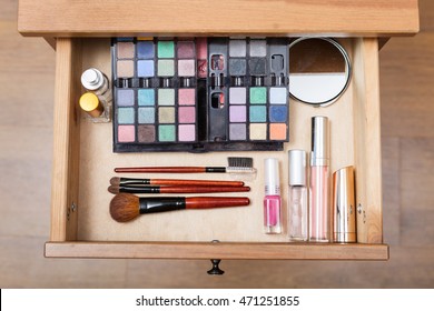 top view of makeup set in open drawer of nightstand - Shutterstock ID 471251855