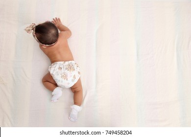 Top View Of The Malay Baby Turning About To Crawl