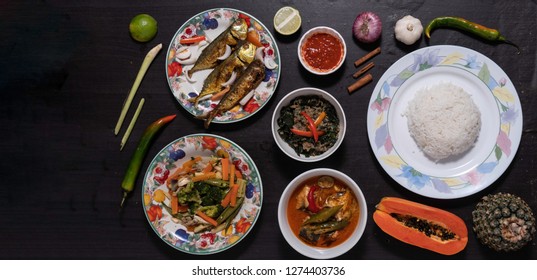 Top View Of Malay Lunch Food On Wooden Background