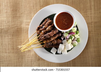 Top View Of Malaysian Food Satay On The Plate With The Cucumber And Ketupat