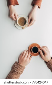 Top View Of Male And Female Hands With Cups Of Coffee On White