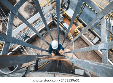 Top view male worker climbs up the ladder inspection stainless tank work at height safety - Powered by Shutterstock