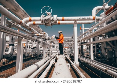 Top view male worker inspection at steel long pipes and pipe elbow in station oil factory during refinery valve of visual check record pipeline oil and gas industry - Powered by Shutterstock