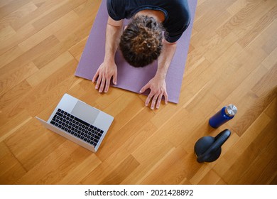 Top View Of A Man Doing Plank On The Floor During An Online Exercise Class At Home.