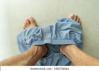 Top View Of Man Foot With Boxer Underware While Using Toilet