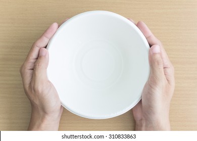 top view of man hand with empty bowl
