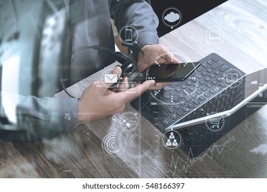 Top View Of Man Hand Using VOIP Headset With Digital Tablet Computer Docking Keyboard,smart Phone,it Support, Call Center And Customer Service Help Desk On Wooden Table,virtual Interface Icons Screen