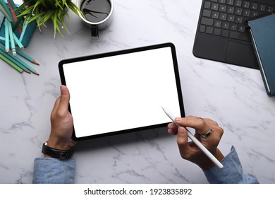 Top view of man hands holding stylus pen and digital tablet with empty screen on marble background. - Powered by Shutterstock