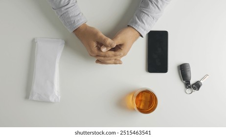 Top view of man puts an envelope with money bills on the table, borrowing or giving credit, smartphone and car keys at the side.