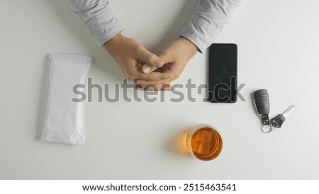 Top view of man puts an envelope with money bills on the table, borrowing or giving credit, smartphone and car keys at the side.