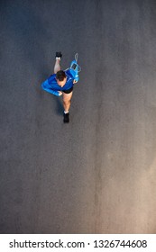 Top View Of Man Running On The Street. On Arm Smart Phone. Healthy Lifestyle Concept.