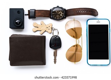 Top view of man set: watches,camera,wallet,car keys, sunglasses,and smartphone on white background; Travel set
