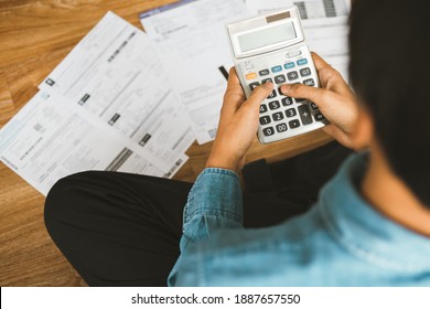 Top View Man Sitting On The Floor Stressed And Confused By Calculate Expense From Invoice Or Bill, Have No Money To Pay Thinking Of Taking The House To Mortgage Causing Debt, Bankruptcy Concept.