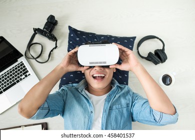 Top view of Man wearing virtual reality goggles - Shutterstock ID 458401537