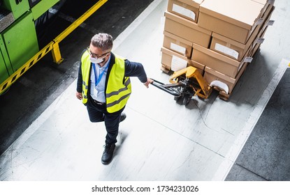 Top view of man worker with protective mask working in industrial factory or warehouse. - Powered by Shutterstock