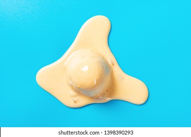 Top View Mango Flavor Ice Cream Ball In A Melting Process On Blue Background