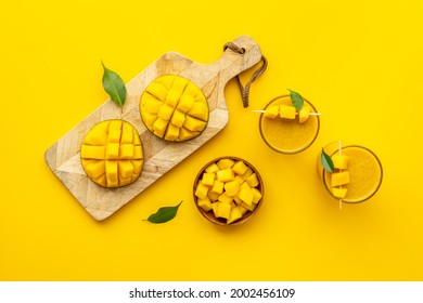 Top view of mango slices and cubes with fresh mango smoothie