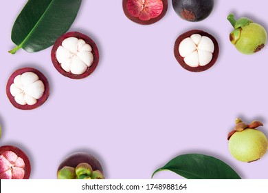 Top view Mangosteens isolated on purple background.