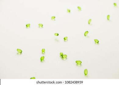 Top view many gel capsules on white background isolated. Vitamin E 200 mg capsules.