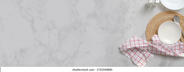 Top View Of Marble Dinning Table With White Ceramic Plates On Placemat, Silverware, Seasoning Bottles, Napkin And Copy Space