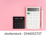 Top view of March 2025 calendar and white calculator with pen on pink background, Position with copy space.