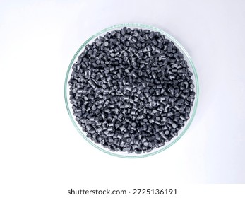 Top view, masterbatch granules, polymer carrying pigment poured into a glass cup forming a circle with a white background, as a product catalog design for a plastic industry company profile