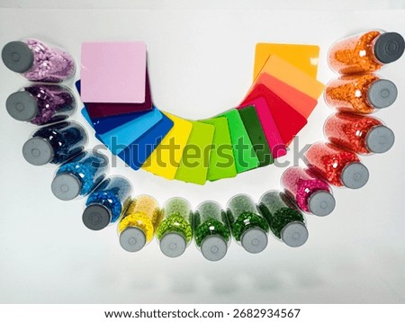 top view, masterbatch variations in glass bottles with chips, polymer carrying pigment isolated on a white background, suitable for product catalog design of industrial plastic company profiles