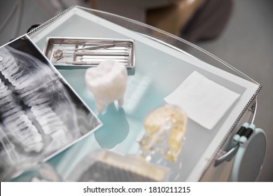 Top view of medical table set up with dental tools, props and dental radiogram