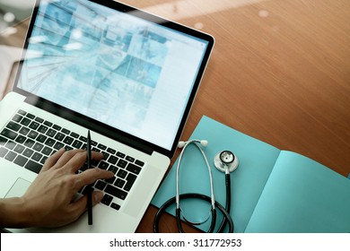 Top View Of Medicine Doctor Hand Working With Modern Computer And Smart Phone On Wooden Desk As Medical Concept