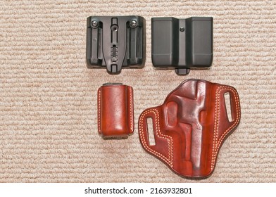 top view, medium distance of a Galco, tan, leather holster and mag holder with two Blackhawk double, mag holders