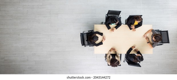 Top View Of Meeting Conference Wooden Table With Six Executives Businesswomen Sitting On Each Chairs Discussing And Talking Business In Team Work In Meeting Room.