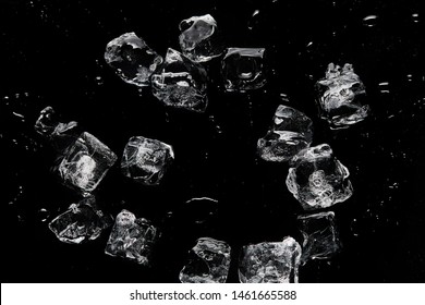 top view of melting transparent refreshing ice cubes isolated on black