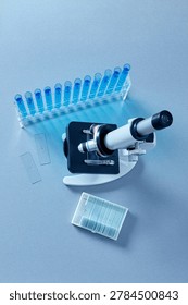 Top view microscope with laboratory slides and blue test tubes