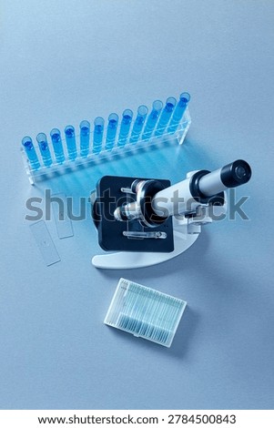 Top view microscope with laboratory slides and blue test tubes