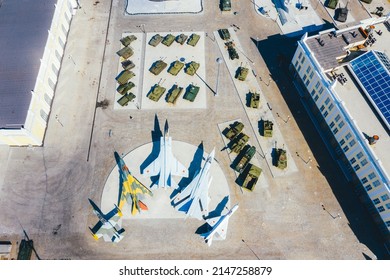 Top View Of The Military Base. Tanks, Self-propelled Howitzers, Rocket Launchers, Helicopters And Aircraft