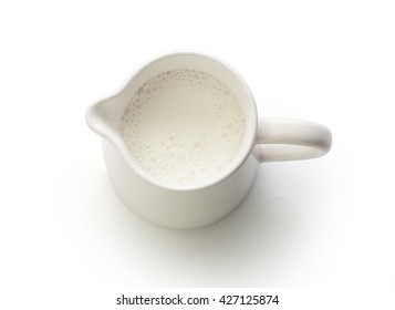 Top View Of Milk Jug With Milk On The White